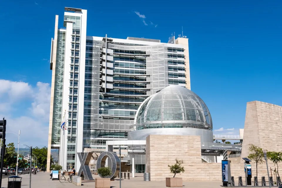 San Jose, California city hall with glass dome in front of modern multistory building.